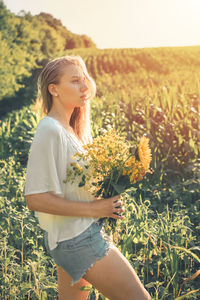 Young woman standing on field