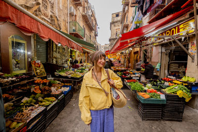 Rear view of man standing in market