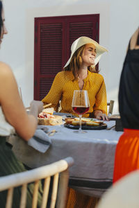 Happy woman sitting at table