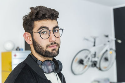 Portrait of man with glasses and headphones in a modern office