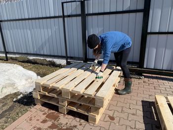 Low section of woman working at garden