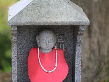 Close-up of statue against stone wall