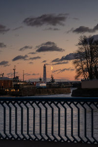 Bridge over river against sky during sunset