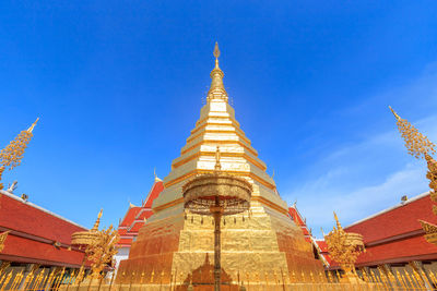 Low angle view of temple building against blue sky