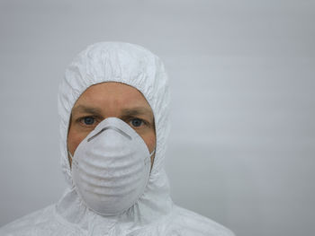 Portrait of man wearing hat against white background