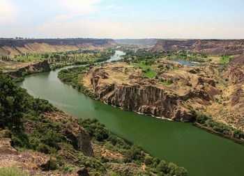 Scenic view of river amidst landscape against sky