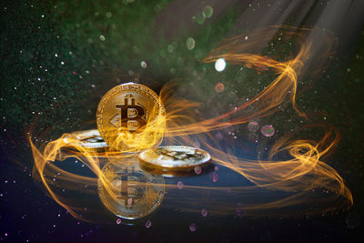 Digital composite image of bitcoins and fire