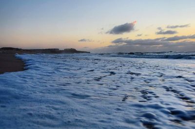 Scenic view of sea against sky at sunset