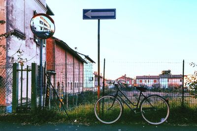 Bicycle in city against sky