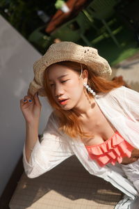 Tilt image of woman wearing hat in cafe