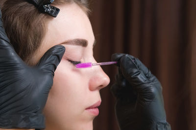 Close-up of woman applying make-up