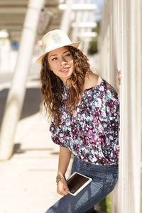 Portrait of young woman sitting outdoors