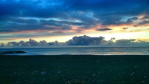 Scenic view of sea against cloudy sky