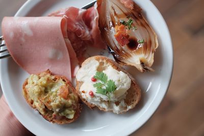 Close-up of hand holding food in plate