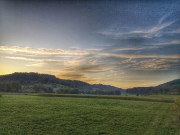 Scenic view of field against sky during sunset