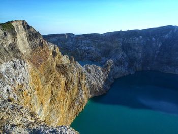 Rock formation in sea against sky