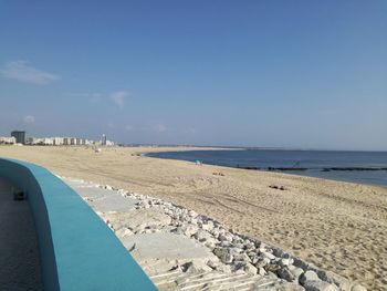 Scenic view of beach against blue sky