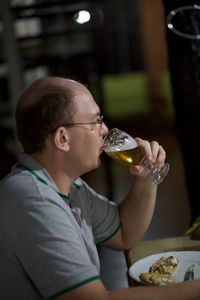 Close-up of man drinking glasses on table at restaurant