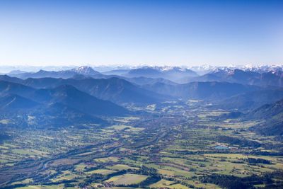 Scenic view of field and mountains against sky