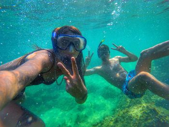 Portrait of people swimming in sea