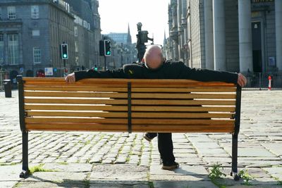 Rear view of man on street in city