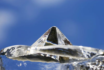 Close-up of glass decoration against blue sky