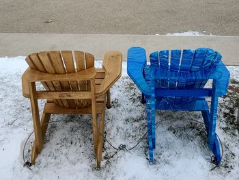 High angle view of empty chairs on snow covered field