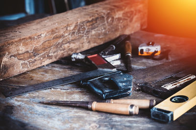 Close-up of old machine part on table