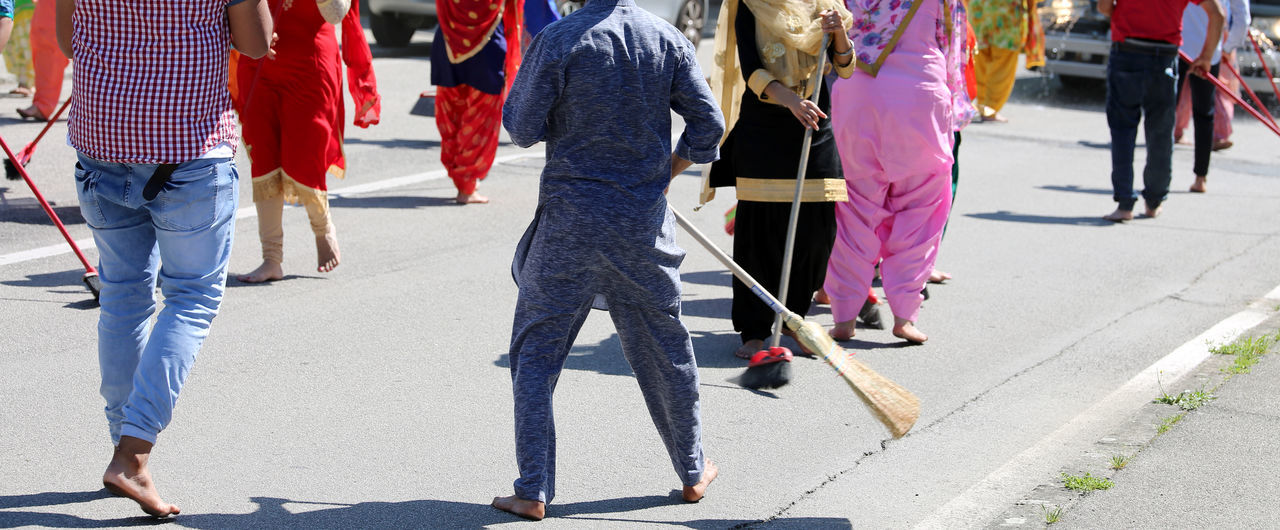 PEOPLE WALKING ON SIDEWALK IN CITY