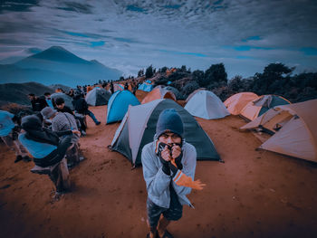 People at beach against sky