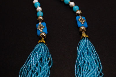 Close-up of blue decoration on table against black background