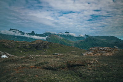 Scenic view of sea and mountains against sky