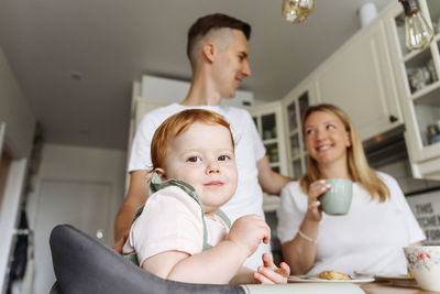 Portrait of mother and daughter sitting at home