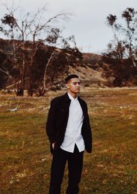 Young man standing on field