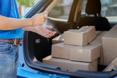 Midsection of man holding car moving