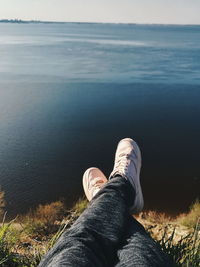 Low section of man on sea shore