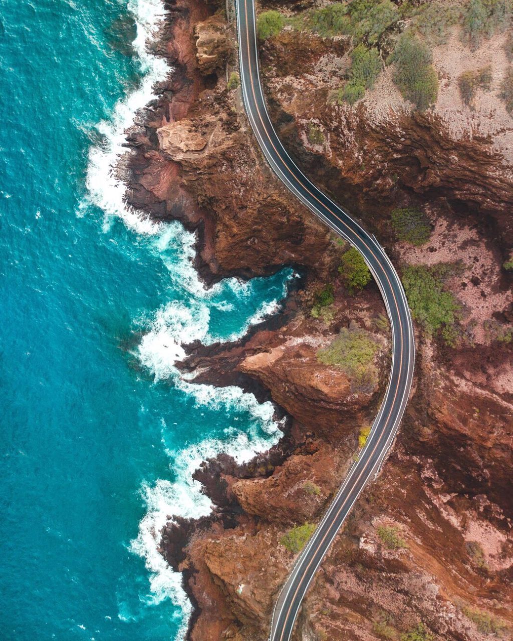HIGH ANGLE VIEW OF WINDING ROAD ON SEA