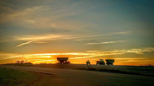 Scenic view of agricultural field against sky during sunset