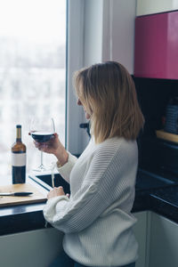 Young woman using mobile phone at home