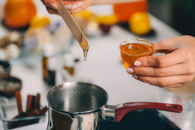 Woman making homemade soap with honey