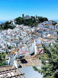 High angle view of townscape by swimming pool against sky