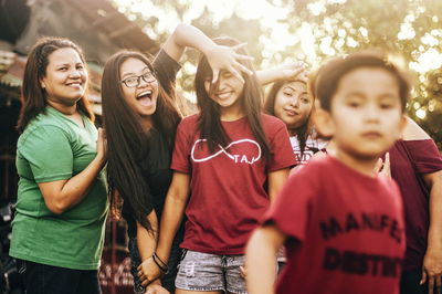 Portrait of smiling young women standing outdoors