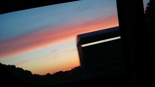 Close-up of silhouette tree against orange sky