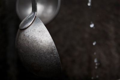 Close-up of metal ladles