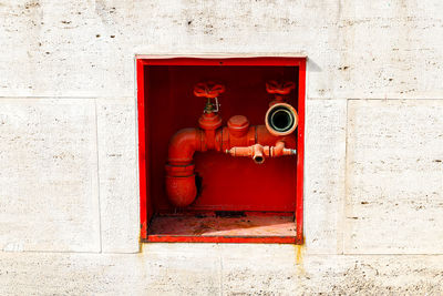 Red pipe on wall