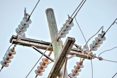 Low angle view of utility pole against clear sky