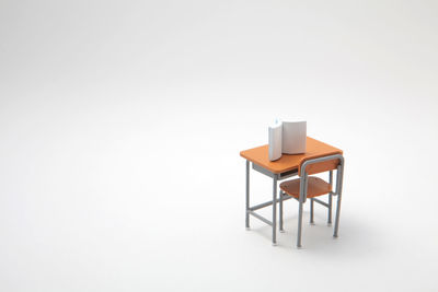 High angle view of toy table with book against white background