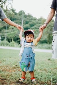 Full length of cute baby girl on field