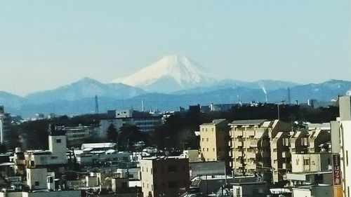 Cityscape with mountain range in background