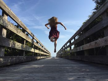 Full length of woman jumping in mid-air